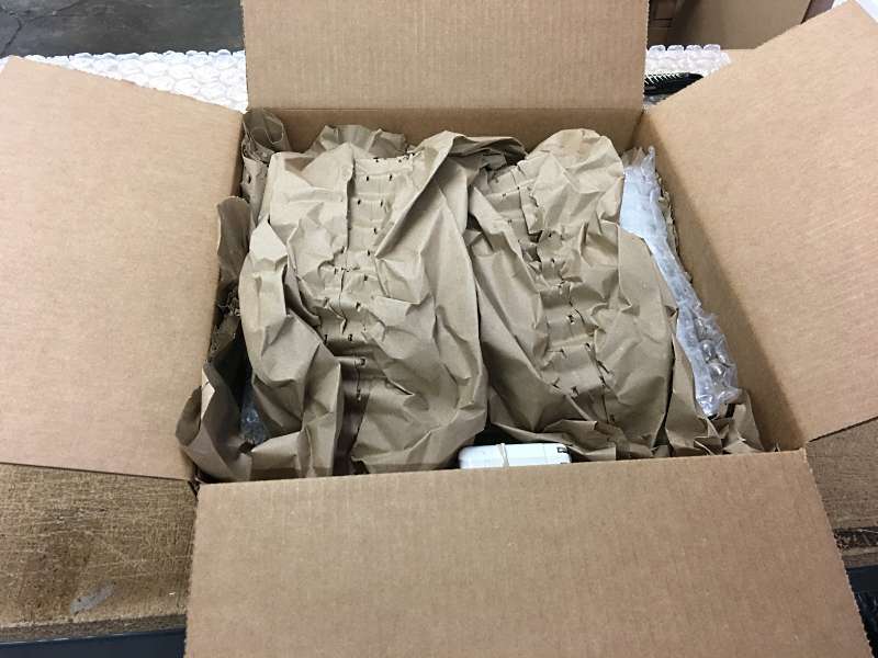 Kraft paper is used as box filler for shipping a used and refurbished Macbook Pro.