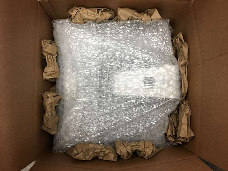 The used discount iMac is surrounded on each side by packing materials before it ships out.